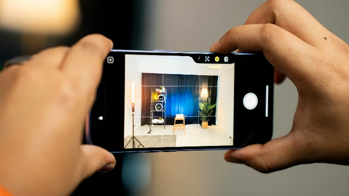 A person taking a picture with a cell phone